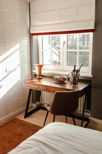 a table in a room with a window and a chair at Villa Monceau Louvain la neuve in Louvain-la-Neuve