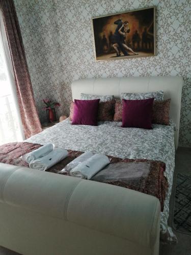 a bedroom with a large bed with purple pillows at Aqua Royal Alexus Luxury Holiday Apartments Girne in Kérynia