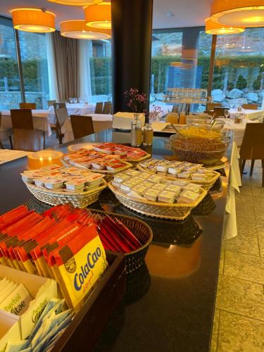 a buffet of food on a table in a restaurant at Aparthotel Siente Boí & SPA in Pla de l'Ermita