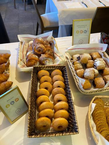 a table with trays of donuts and pastries on it at Aparthotel Siente Boí & SPA in Pla de l'Ermita