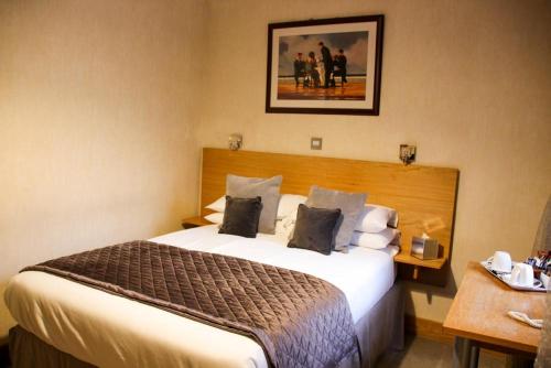 a hotel room with a large bed in it at Station Hotel And Restaurant in Melrose