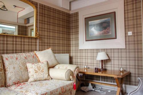 a living room with a couch and a table at Station Hotel And Restaurant in Melrose