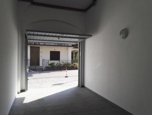 a hallway with an open door to a building at Danilo Apartments in Baveno