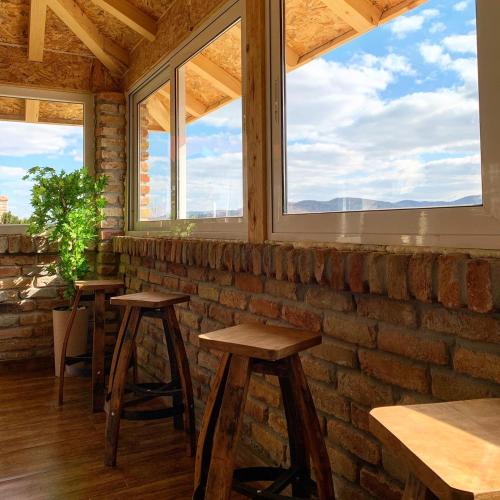 a room with two stools and two windows at Vila Impresija, Fruška gora in Novi Sad