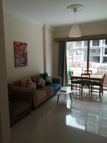 a living room with a couch and a table at Aqua Royal Alexus Luxury Holiday Apartments Girne in Kérynia