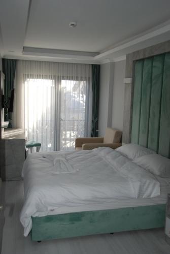 a bedroom with a large bed with a green headboard at Little sofia hotel in Istanbul