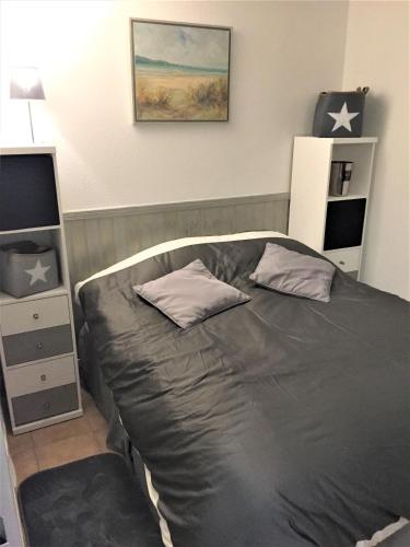 une chambre avec un lit avec deux oreillers dessus dans l'établissement APPARTEMENT 4 PERSONNES PORT GRIMAUD - COTE D'AZUR, à Grimaud