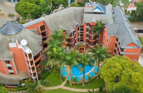 an aerial view of a building with a swimming pool at Kibo Palace Hotel Arusha in Arusha
