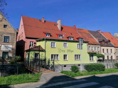 a green building with a red roof at Apartament w Karkonoszach Stary Młyn in Kowary