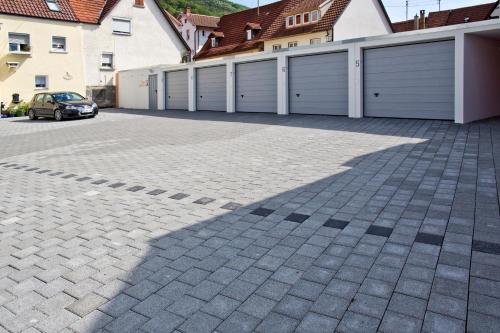 a parking lot with two garage doors and a car at Hotel Buck in Bad Urach