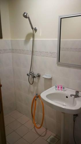 a bathroom with a sink and a mirror at Pangkor staycation apartment in Pangkor