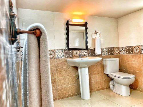 a bathroom with a sink and a toilet and a shower at Riad Al Madina in Essaouira