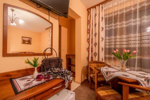a bathroom with a table and a mirror at Willa u Zwijaczy in Zakopane