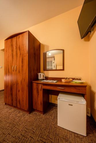 a room with a wooden desk with a mirror at Willa u Zwijaczy in Zakopane