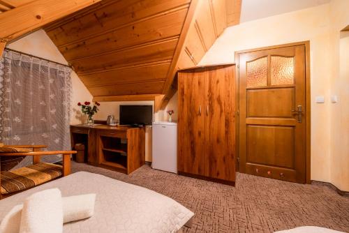 a room with a kitchen with a refrigerator and a door at Willa u Zwijaczy in Zakopane