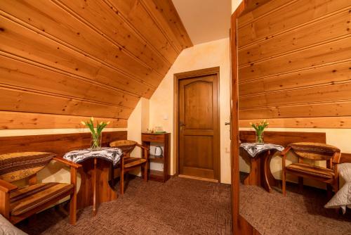 a room with two tables and chairs and a door at Willa u Zwijaczy in Zakopane
