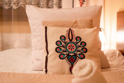 a pillow with a mandala design on a bed at Willa u Zwijaczy in Zakopane