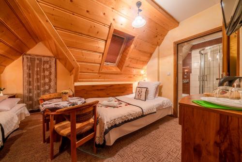 a bedroom with a bed and a sink in a room at Willa u Zwijaczy in Zakopane