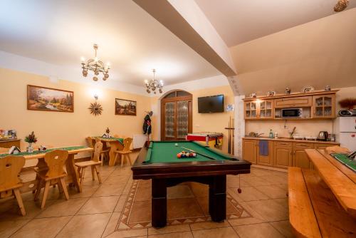 a living room with a pool table and a kitchen at Willa u Zwijaczy in Zakopane