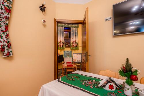 a room with a table with a christmas blanket on it at Willa u Zwijaczy in Zakopane