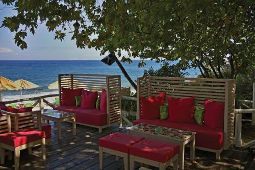 a deck with two chairs and a table and the ocean at Hotel Vlassis in Stómion