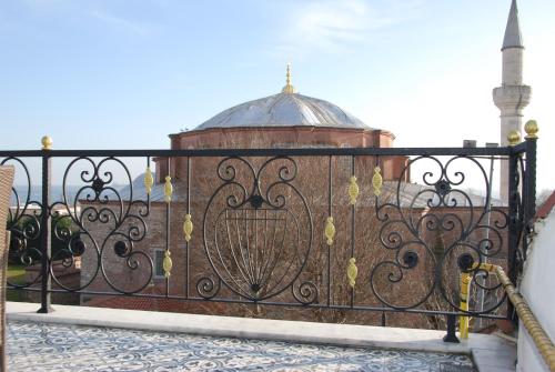 an iron gate with a mosque in the background at Little sofia hotel in Istanbul