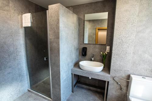 a bathroom with a sink and a shower at Hotel Novy Kastiel - Self check-in in Topoľčany