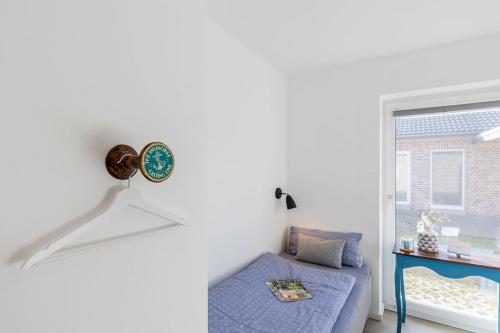 a living room with a blue couch and a window at lovely&cool STIL-HAUS in Fehmarn
