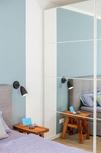 a bedroom with a bed and a table and a couch at lovely&cool STIL-HAUS in Fehmarn