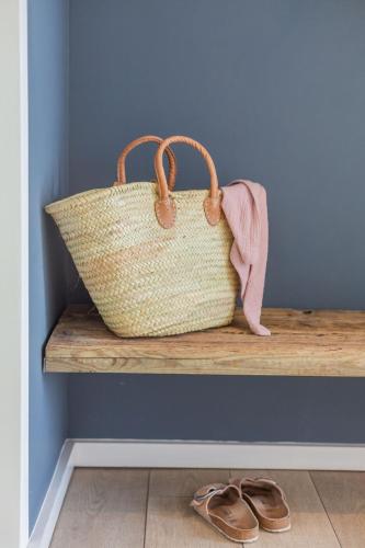 a purse sitting on a bench next to a pair of shoes at lovely&cool STIL-HAUS in Fehmarn