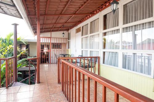 a balcony of a house with a wooden railing at Casa Hotel Sura in San José