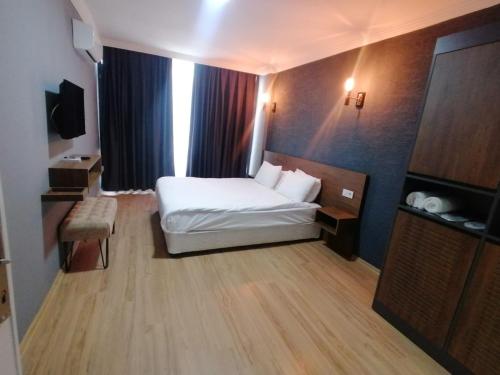 a hotel room with a bed and a television at Beta GuestHouse in Antalya