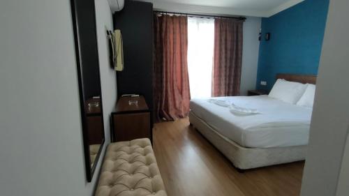 a hotel room with a bed and a window at Beta GuestHouse in Antalya