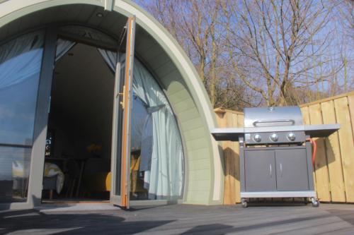 a barbecue grill sitting outside of a building at Lough Erne Glamping Pod in Enniskillen