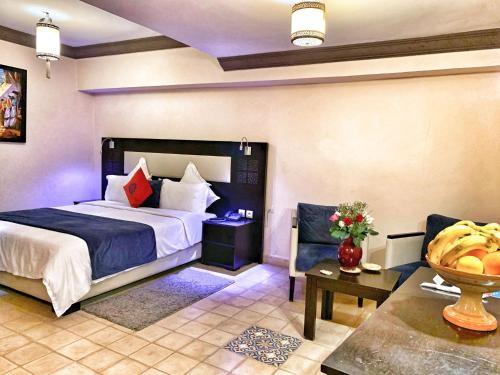 a hotel room with a bed and a table at Riad Al Madina in Essaouira