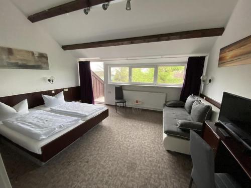 a bedroom with a large bed and a couch at K 357 - Low budget Hotel in Ratekau bei Lübeck in Ratekau