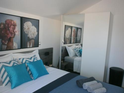 sypialnia z łóżkiem z niebiesko-białymi poduszkami w obiekcie Apartment Royal w Szybeniku
