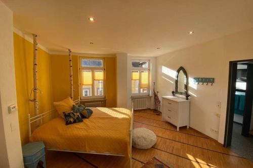 a bedroom with a bed and a mirror at CASA UNA im Herzen von Bad Kreuznach in Bad Kreuznach
