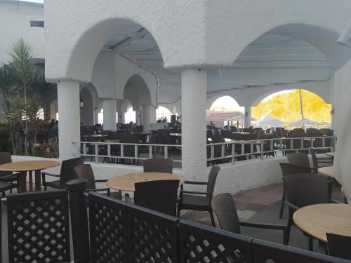 an outdoor patio with tables and chairs and tables and tablesktop at Sierra Mar All Inclusive at Tesoro in Manzanillo