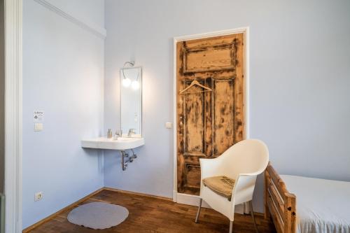 a bedroom with a bed and a sink and a mirror at Villa Schmidt in Pirna