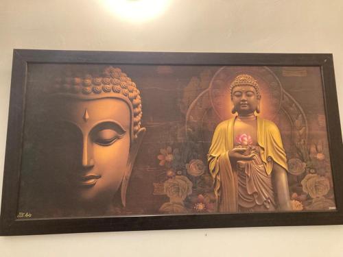 a picture of a statue on a wall at Hotel Arrow 19 in Bareilly