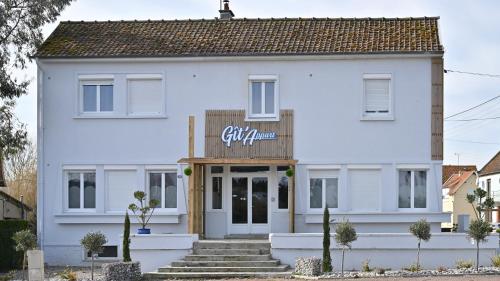 a white building with a sign on it at Git'appart in Airaines