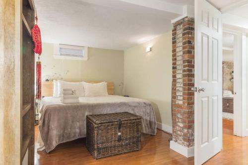 a bedroom with a bed and a brick pillar at Parking - Private Entrance - King Beds in Boston