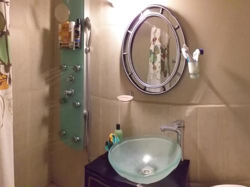 a bathroom with a sink and a mirror at Angelina's House by L&L in Mar del Plata