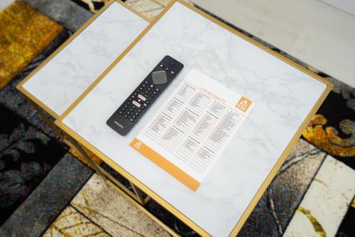 a remote control sitting on top of a table at SHIMresidence LUXURY in Rădăuţi