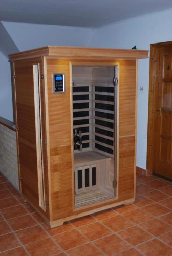 a large wooden enclosure with a vent in a room at Casa Napsugár Panzió in Apostag