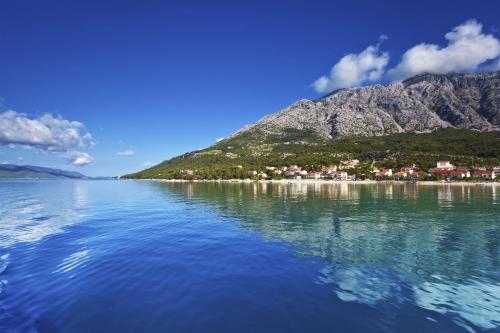 a large body of water with a mountain in the background at Aminess Younique Bellevue Hotel in Orebić