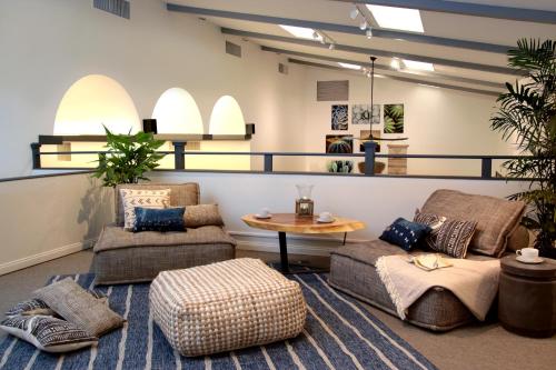 a living room with two chairs and a table at Azure Palm Hot Springs in Desert Hot Springs
