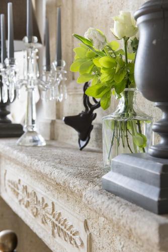 a vase with flowers in it on a table at Clos Marcamps - Teritoria in Prignac-et-Marcamps