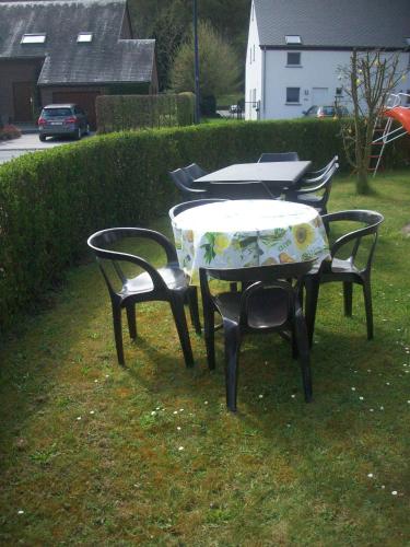 two chairs and a table with a tablecloth on it at Chez Lola in La Roche-en-Ardenne